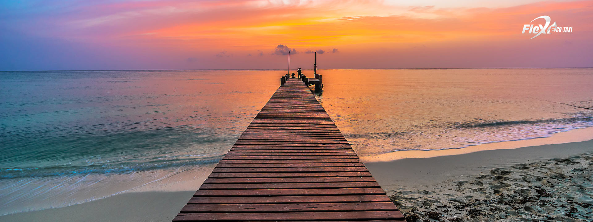 Stunning sunset over the turquoise waters of Cozumel, showcasing vibrant orange and pink hues, a perfect end to a day in paradise.