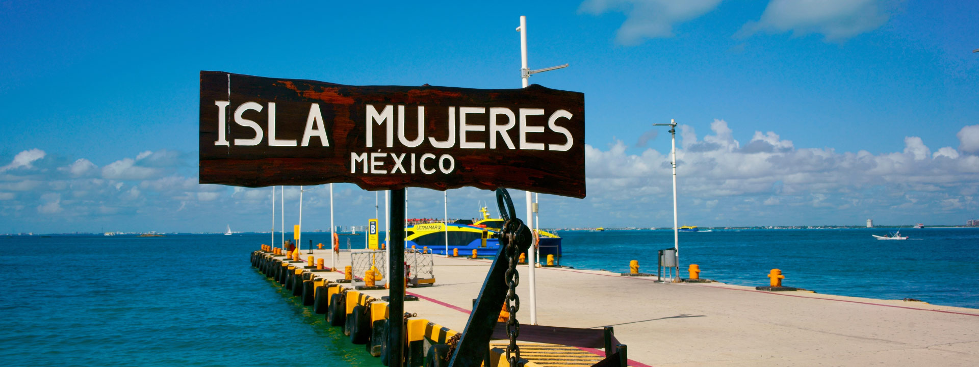 Ferry sailing to Isla Mujeres from Cancun, with the Caribbean Sea in the background.