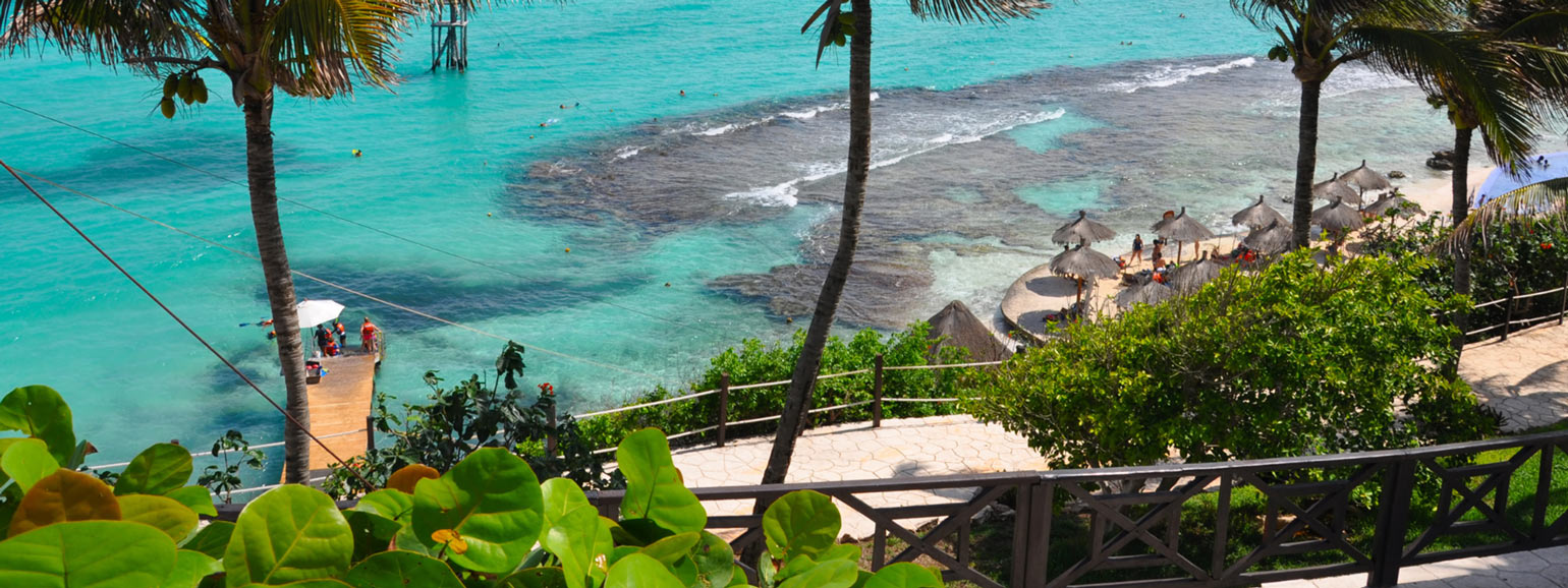 Panoramic view of Punta Sur in Isla Mujeres, featuring cliffs and crystal-clear waters.