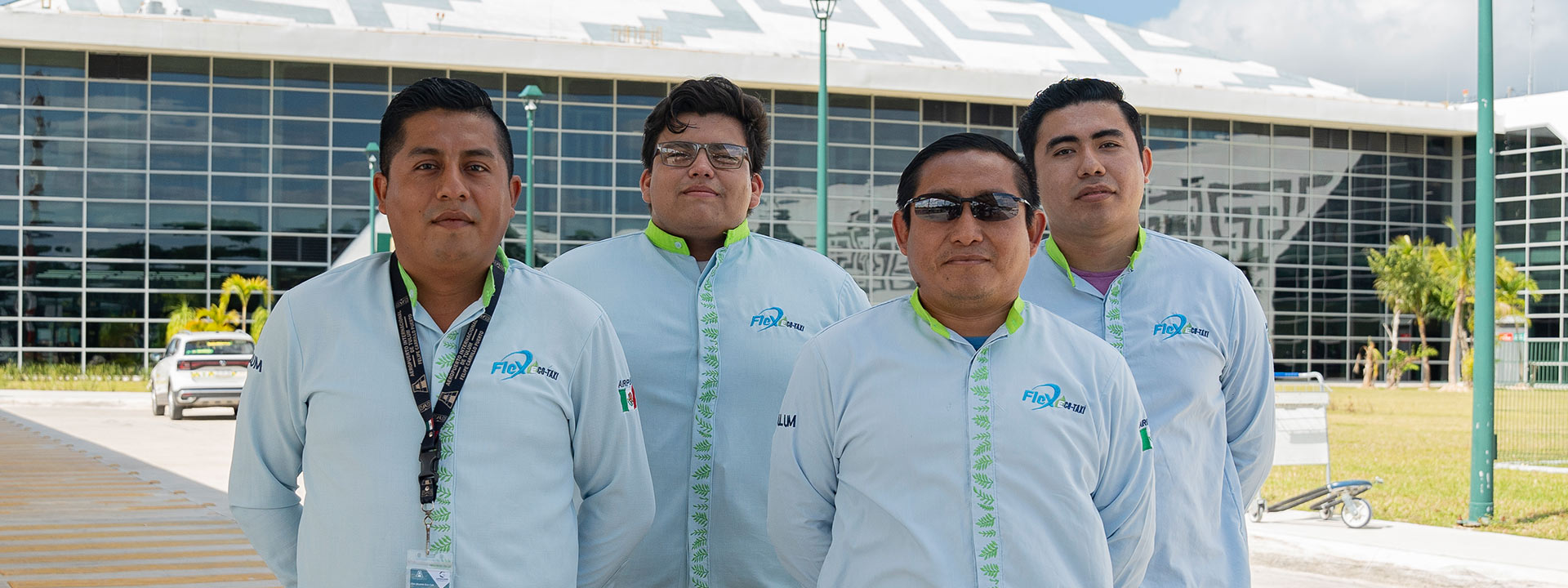 Flex Eco Taxi drivers standing outside Tulum Airport, ready to provide safe and reliable airport transfers.